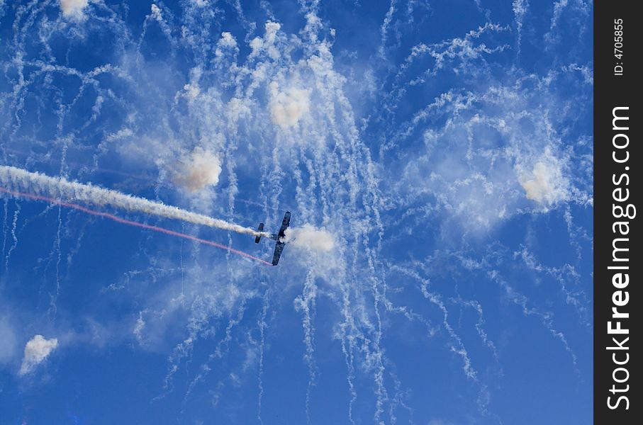 Plane flying through fireworks at airshow