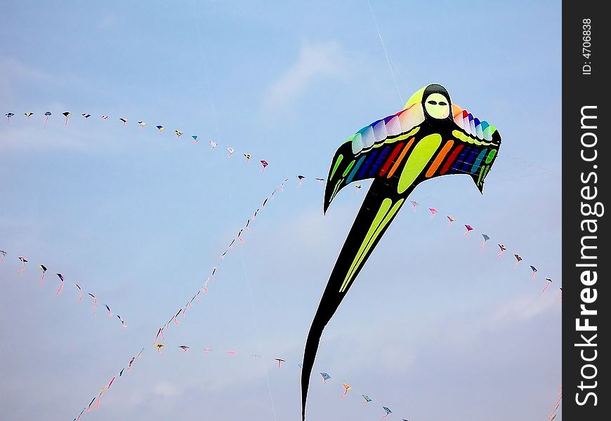 The shaped colored kite on the background of sky. The shaped colored kite on the background of sky