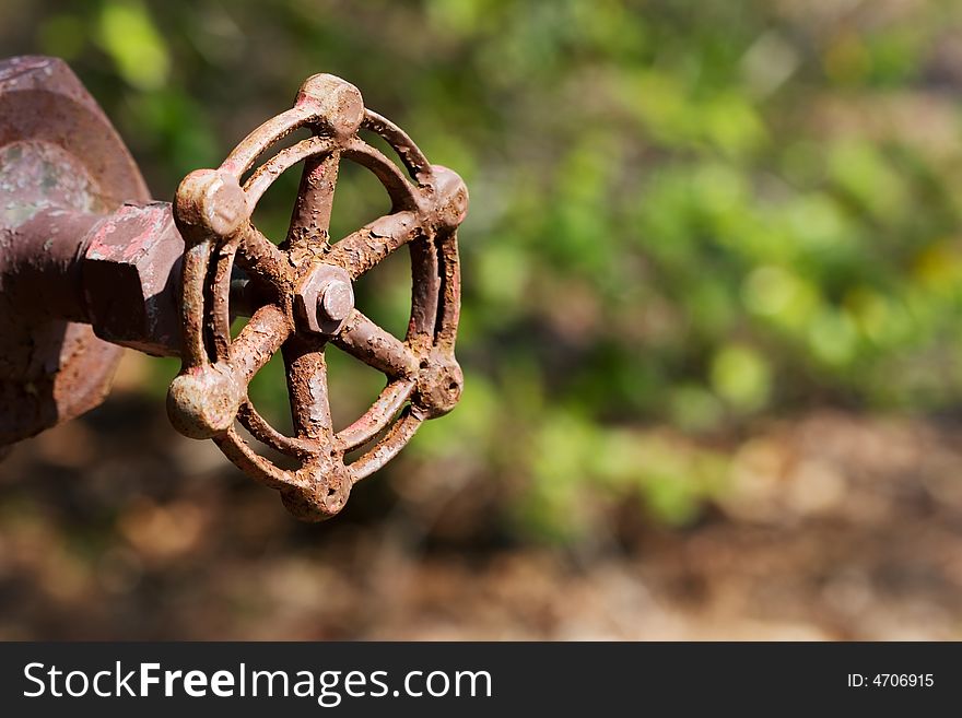 Old rusty valve with blurry background