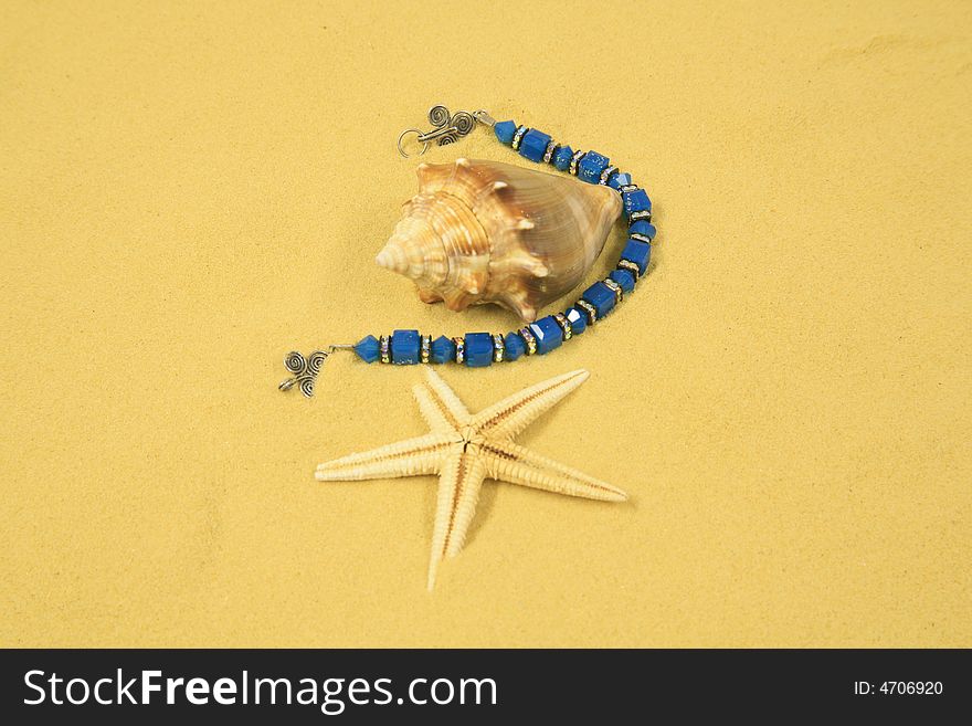 Seashells, Starfish & Jewelry set in Beachsand. Seashells, Starfish & Jewelry set in Beachsand