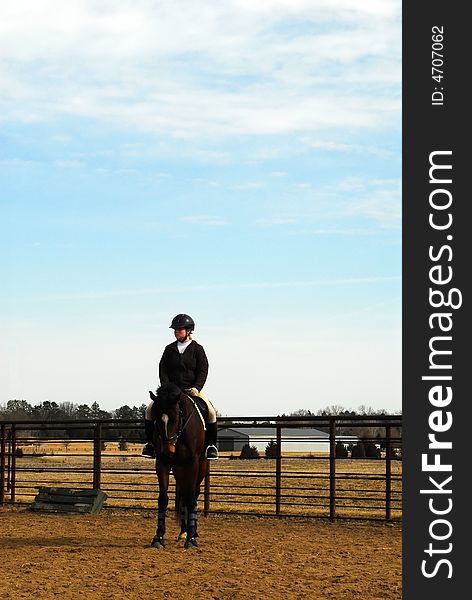 Young woman on horse in late afternoon with blue sky. Young woman on horse in late afternoon with blue sky.