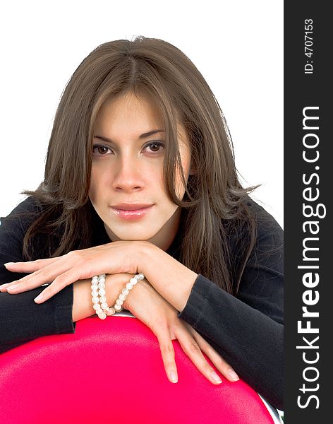 Portrait of a cute beautiful girl with a red chair