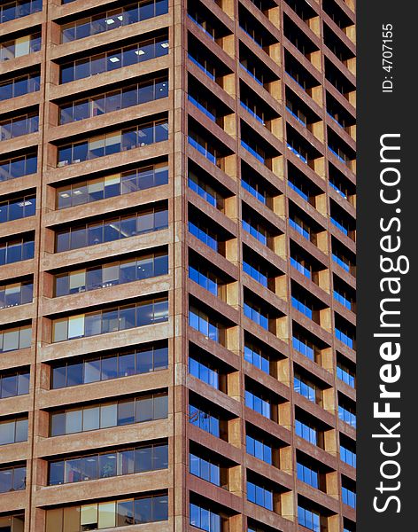 Abstract image of brown office tower with blue sky reflecting off windows. Abstract image of brown office tower with blue sky reflecting off windows