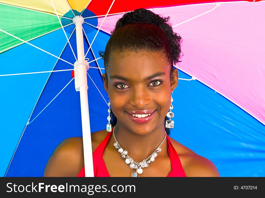 Charming african girl with a colorful umbrella