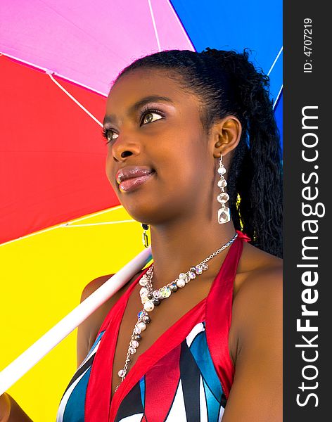 Charming african girl with a colorful umbrella