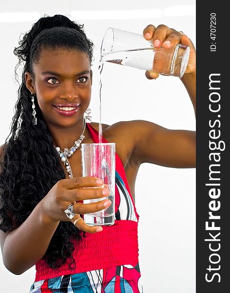 Sweet african girl pouring water into a glass