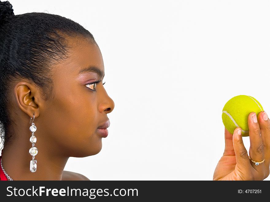 Sweet adorable young lady with a yellow tennis ball