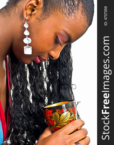 Sweet adorable young lady with a colorful wooden goblet. Sweet adorable young lady with a colorful wooden goblet