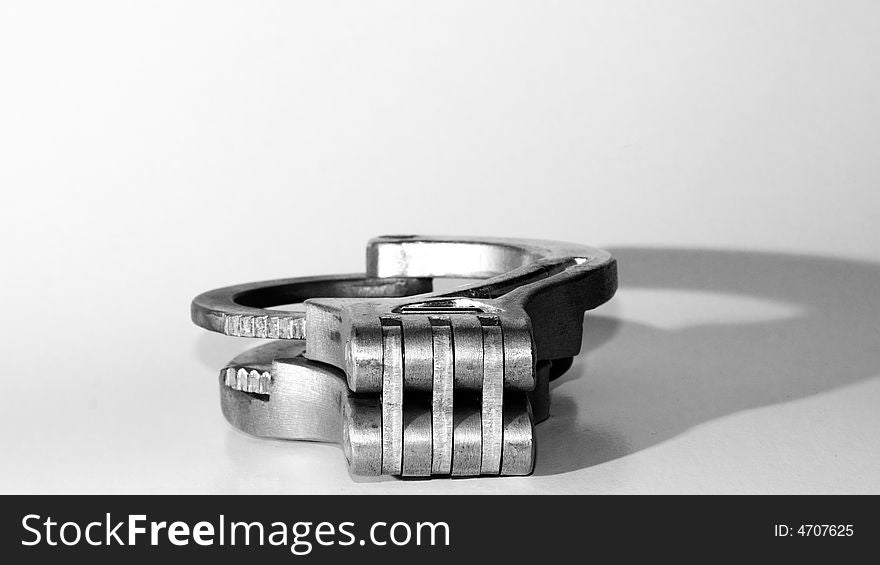 Handcuffs on white background with shadow