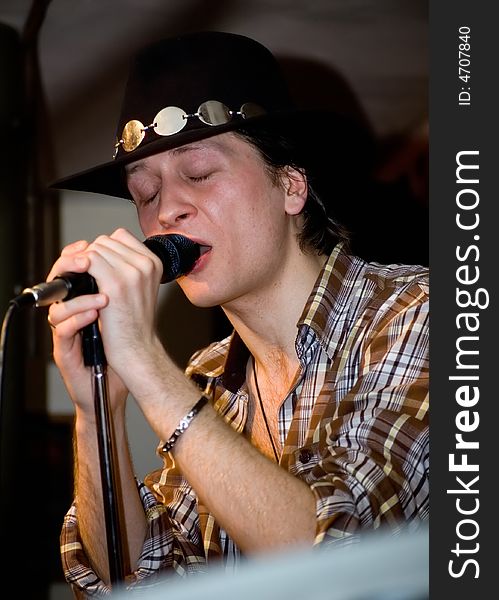 Singer with microphone.  Concert of group StockDog in club the Woman-ljuba. Rostov-on-Don. Russia
