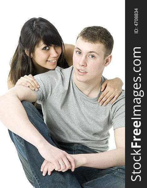 A young couple sitting with each other in a studio. A young couple sitting with each other in a studio