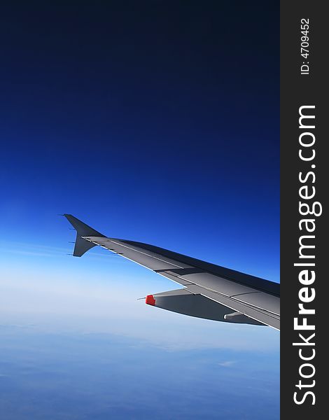 Left wing of the aircraft over clear and cloudless sky. Free space for custom text above the wing. Left wing of the aircraft over clear and cloudless sky. Free space for custom text above the wing.