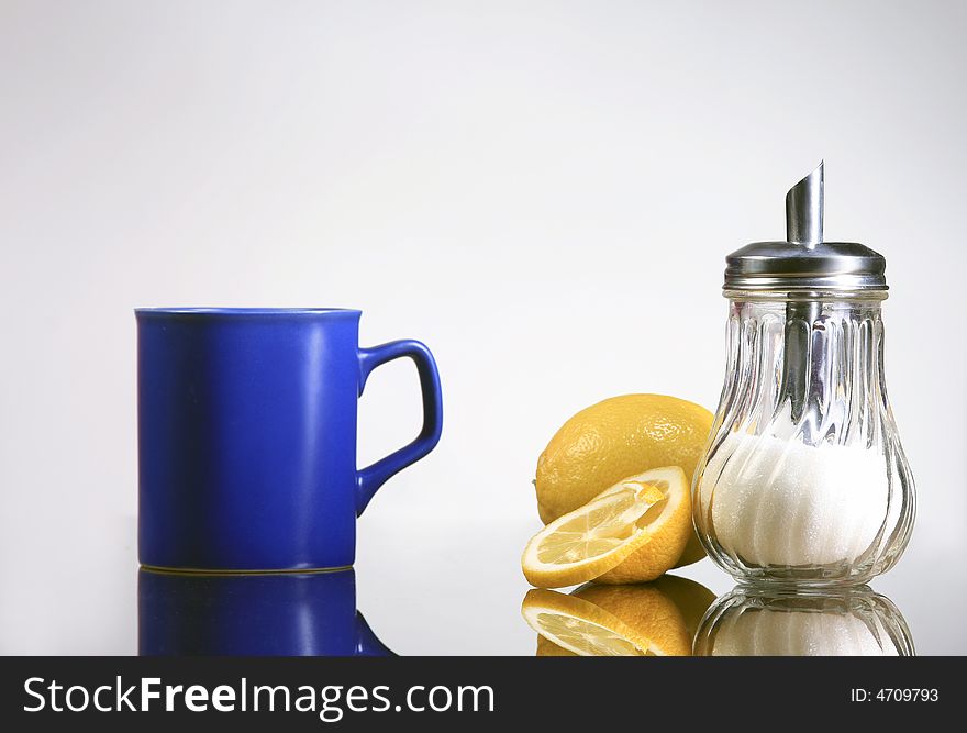 A blue cup of tea with lemons and sugar. A blue cup of tea with lemons and sugar