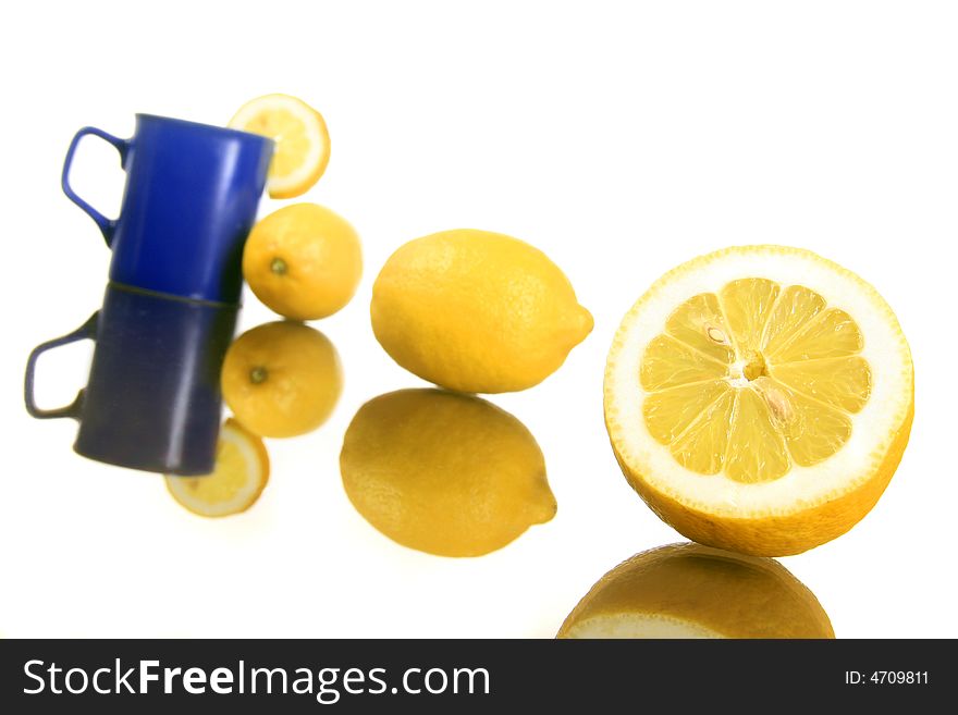 Diagonal shot of a lemons and blue mug. Diagonal shot of a lemons and blue mug