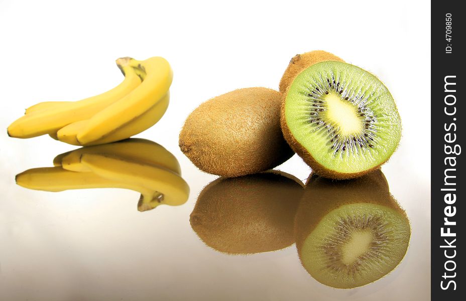 Bananas and kiwis standing on the white. Bananas and kiwis standing on the white