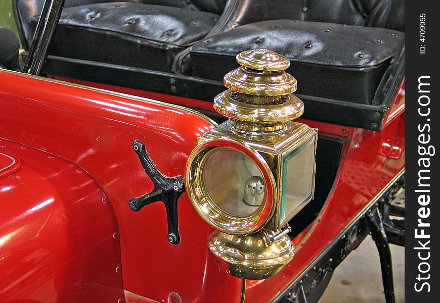 Details of a beautiful red antique car brass lamp. Details of a beautiful red antique car brass lamp