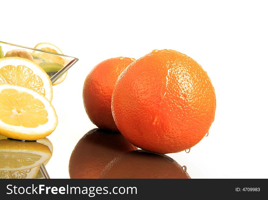 Two oranges with lemon standing together