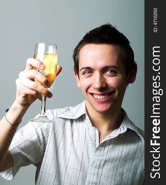 Young man drinking champaign and smiling