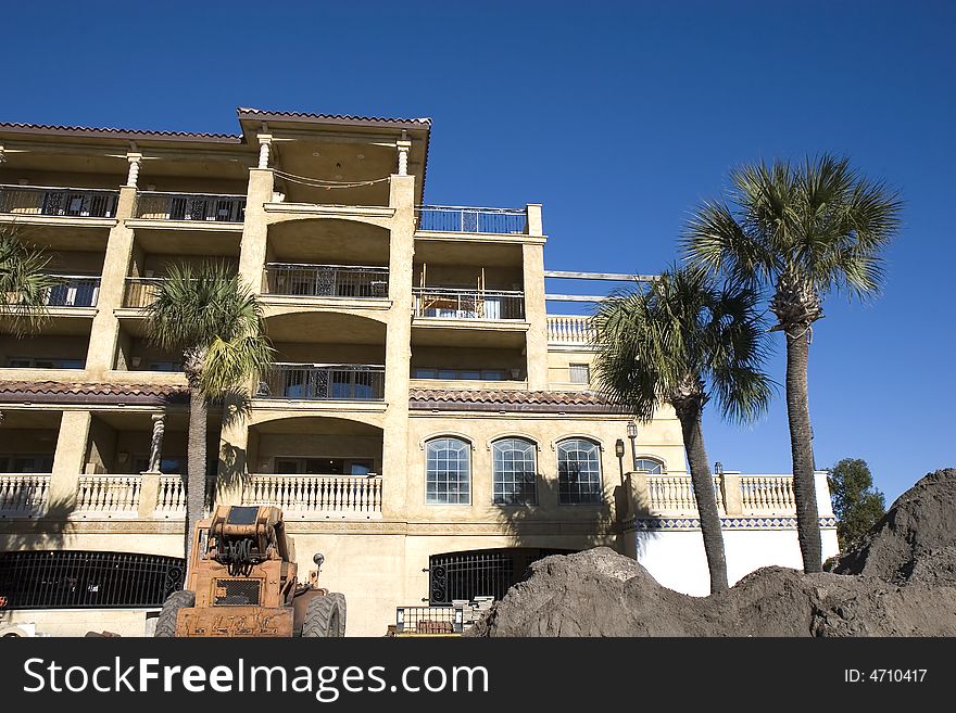 A new condominium construction project of stucco in a tropical setting. A new condominium construction project of stucco in a tropical setting