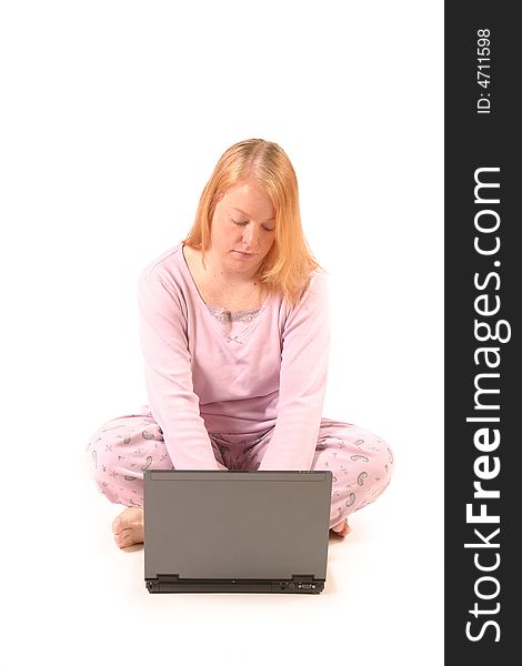 Isolated woman using laptop in pajamas