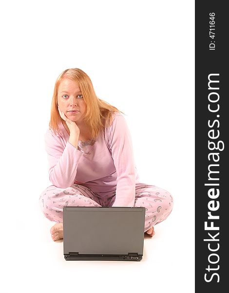 Isolated woman using laptop in pajamas