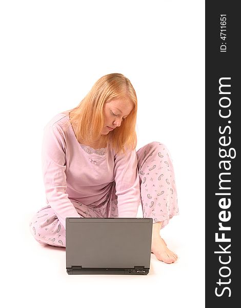 Isolated woman using laptop in pajamas