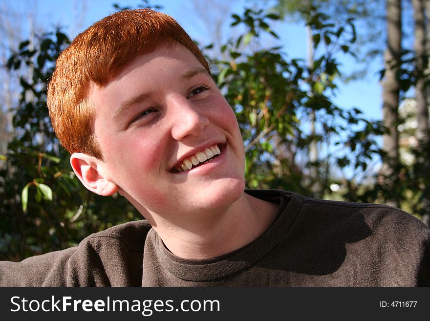 Happy smiling teenage boy outdoors. Happy smiling teenage boy outdoors
