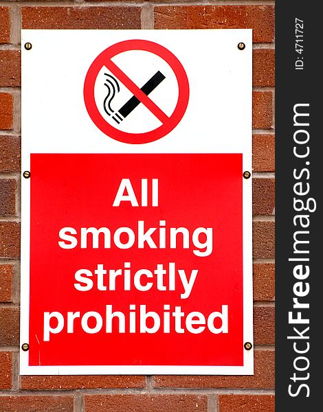 A sign on a wall indicating that smoking is prohibited. A sign on a wall indicating that smoking is prohibited