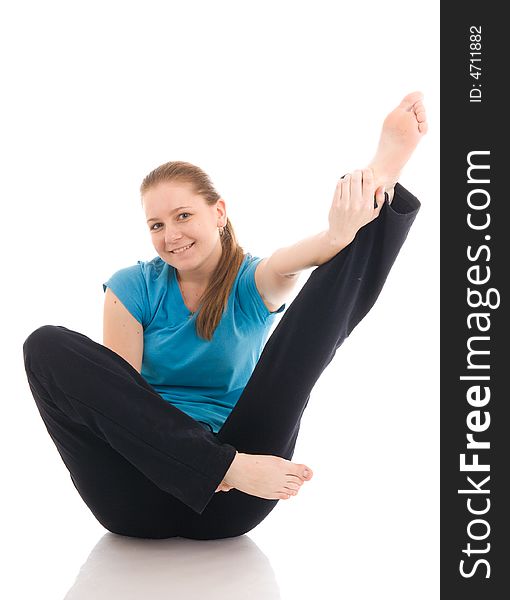 The beautiful young woman doing yoga exercise isolated on a white background. The beautiful young woman doing yoga exercise isolated on a white background