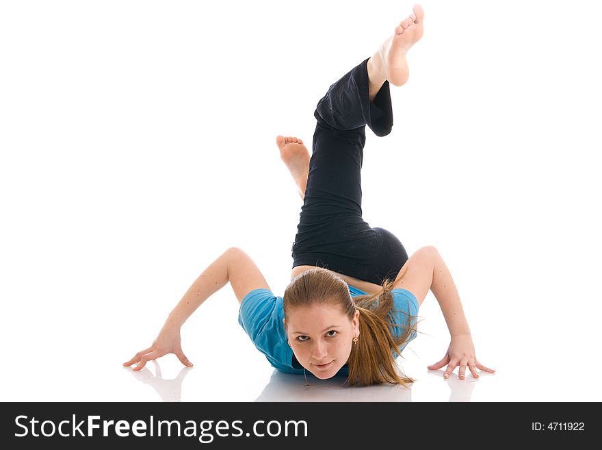 The beautiful young woman doing yoga exercise isolated on a white background. The beautiful young woman doing yoga exercise isolated on a white background