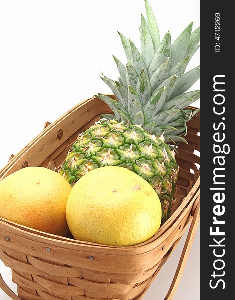 Fresh pineapple and oranges eat form the basket. Fresh pineapple and oranges eat form the basket