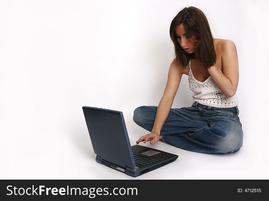 Brunette girl with laptop on white background