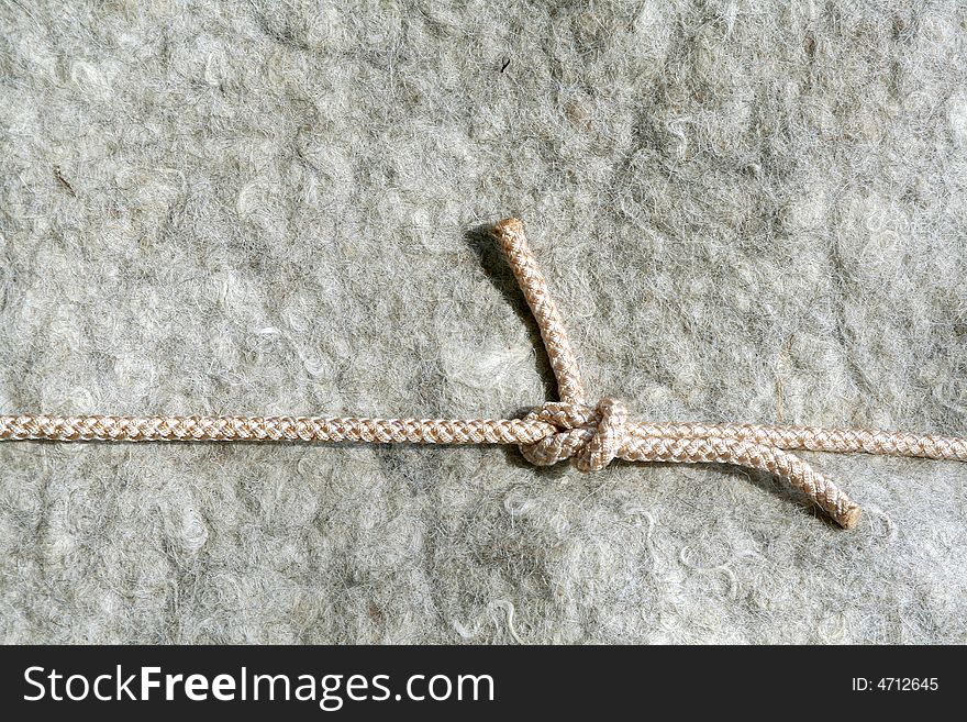 Background material of old wool carped with rope. Background material of old wool carped with rope