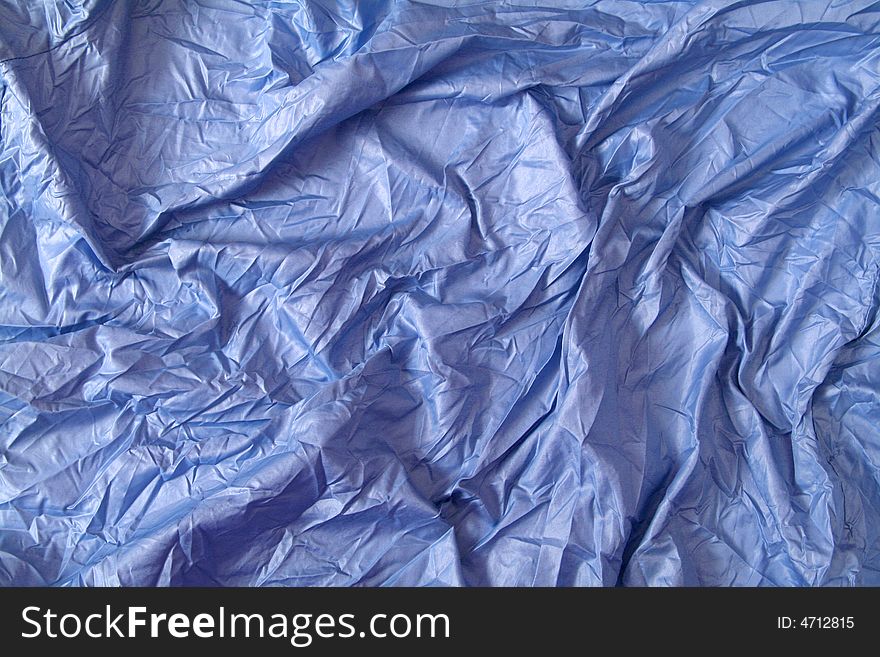 Background. Blue satin fabric with folds