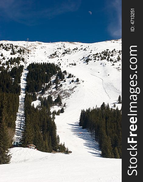 Red piste and chairlift in Meribel Valley, French Alps. Red piste and chairlift in Meribel Valley, French Alps