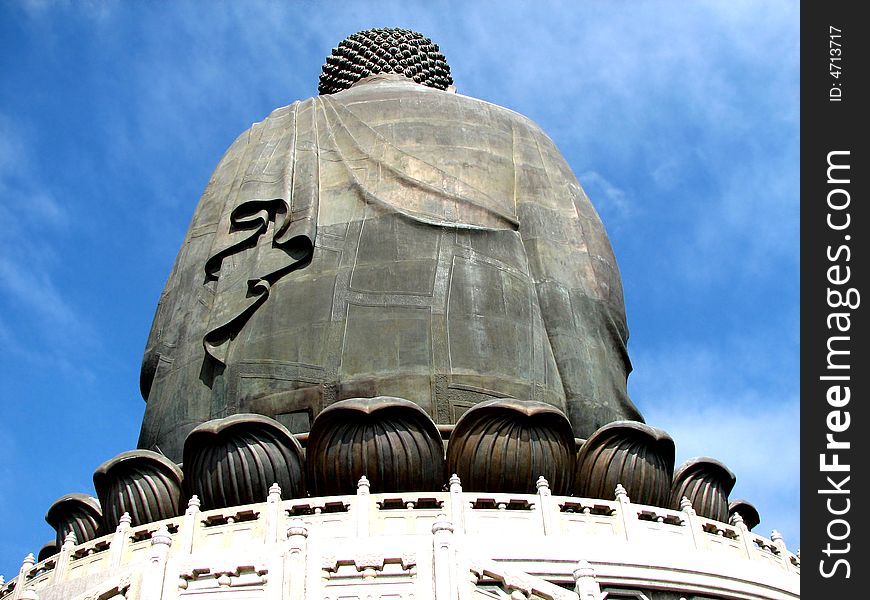 The back of big buddha statue in Hong Kong with a blue sky.