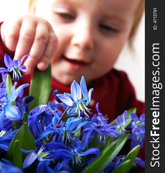 Little girl tries to keep a bouquet