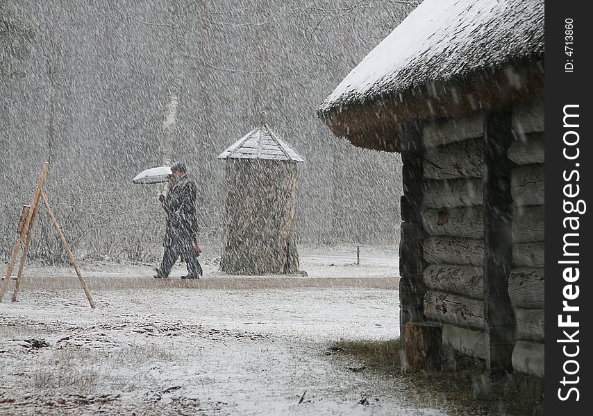 Couple with umbrella walking to park in the snow. Couple with umbrella walking to park in the snow