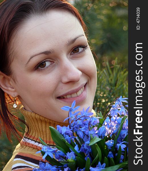 A girl with blue spring flowers. A girl with blue spring flowers