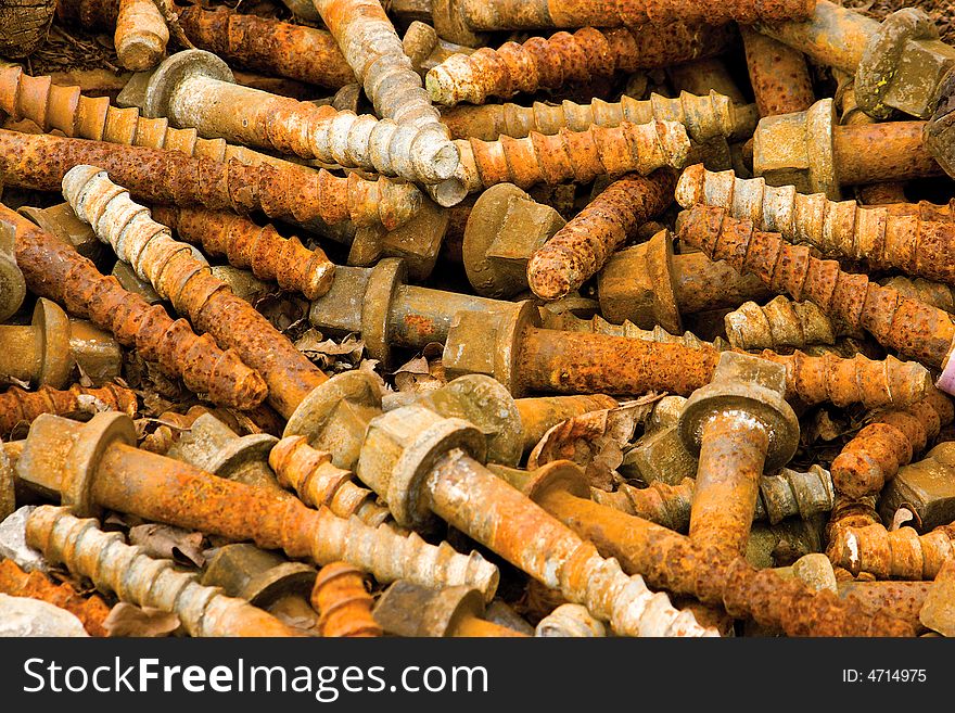 An old pile of rusty railway bolts. An old pile of rusty railway bolts