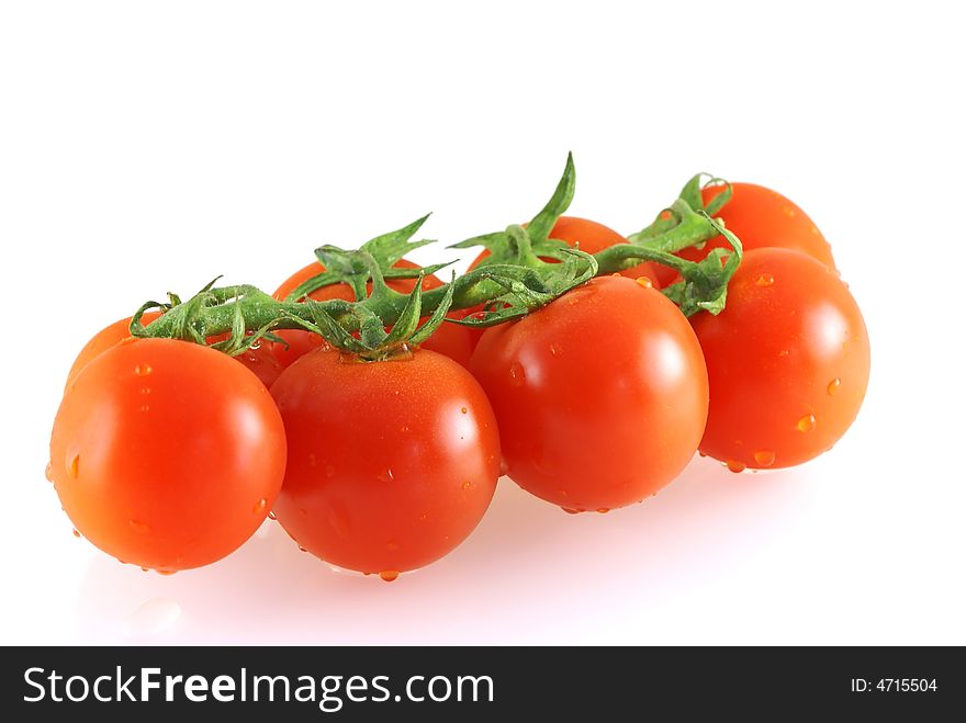 Few fresh tomatoes with water drops over white background