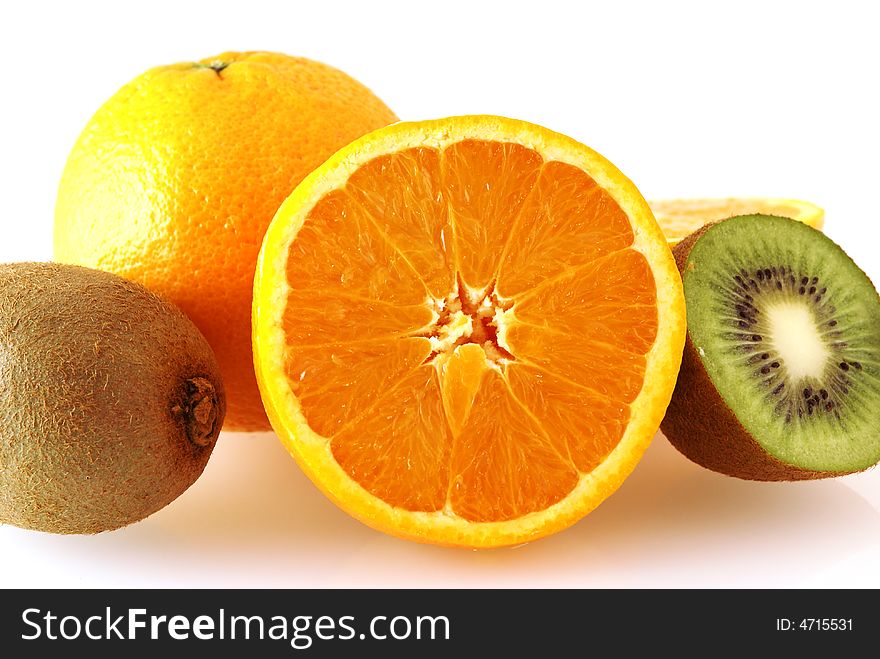 Close up of oranges and kiwi fruits over white background