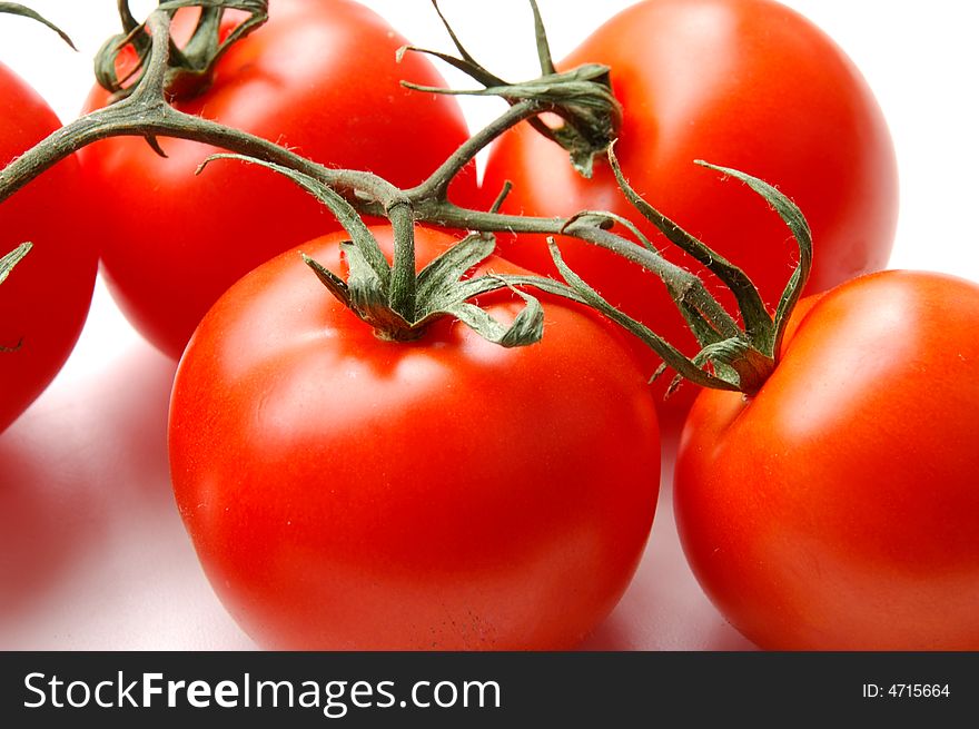 Red tomatos isolated on white with flash