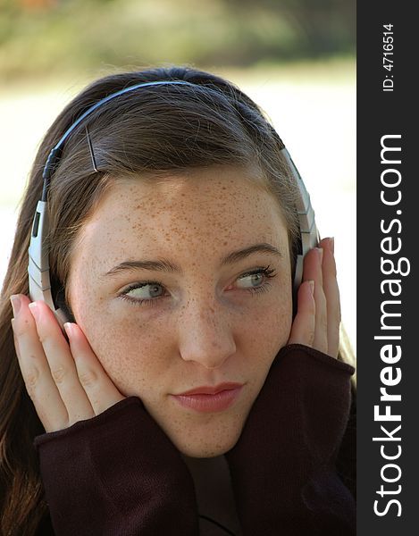 Pretty tween girl listening to music with headphones. Pretty tween girl listening to music with headphones