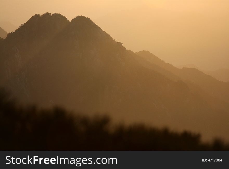 Peaks of one of the most impressive chinese mountains - Huangshan - during the sunrise. Peaks of one of the most impressive chinese mountains - Huangshan - during the sunrise