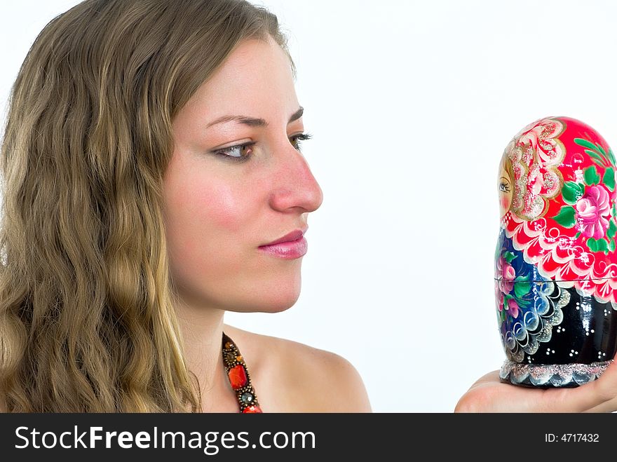 Gorgeous young lady with a wooden coorful doll. Gorgeous young lady with a wooden coorful doll