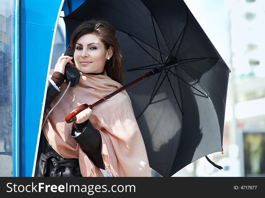 An image of young girl speaking on the telephone. An image of young girl speaking on the telephone