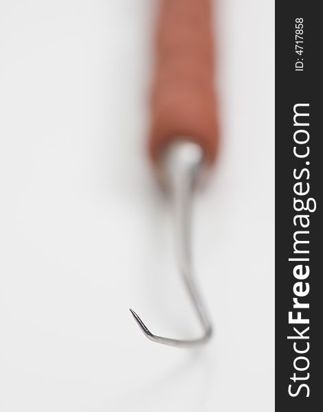 Dental tool (hook) on white background