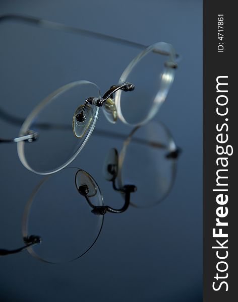 Spectacles without frames on glas. Spectacles without frames on glas