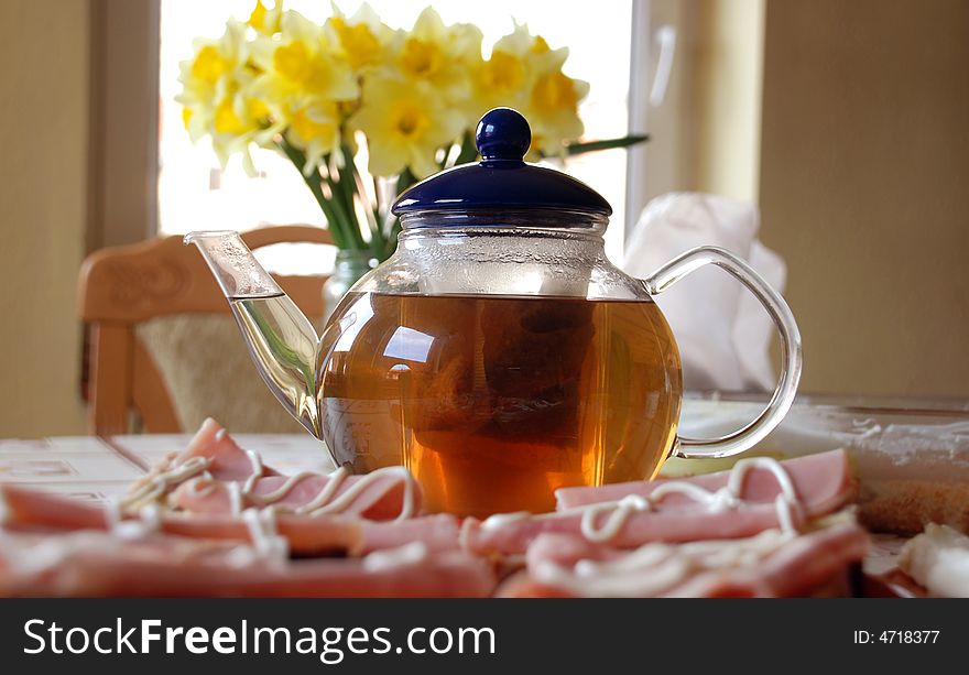 Glass Teapot on the table with sandwiches. Glass Teapot on the table with sandwiches